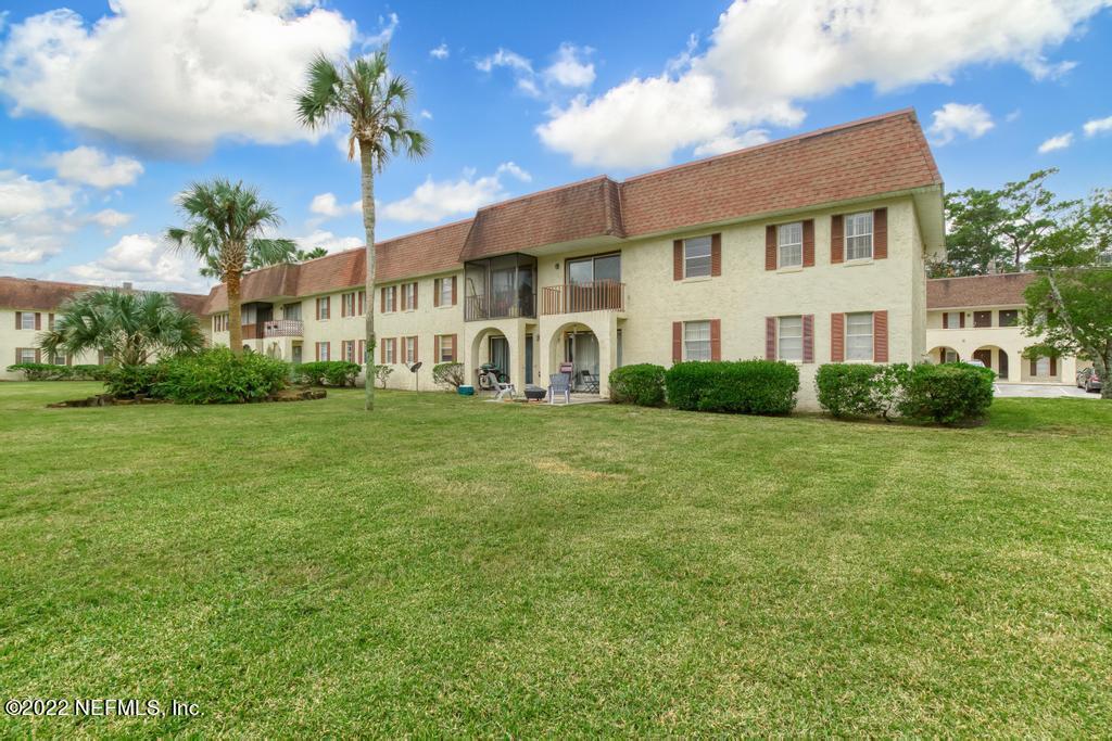 1647 El Camino Road, Unit 5 Jacksonville, FL 32216 - Photo 33 of 44 a view of a white house with a big yard and potted plants