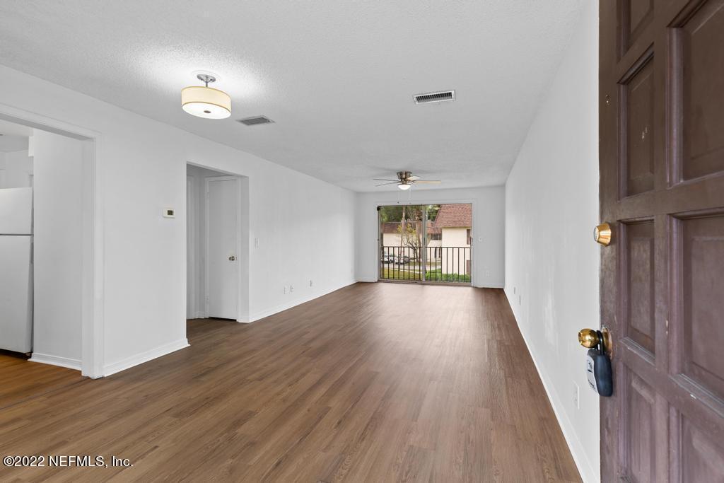 1647 El Camino Road, Unit 5 Jacksonville, FL 32216 - Photo 8 of 44 a view of an empty room with wooden floor and a window