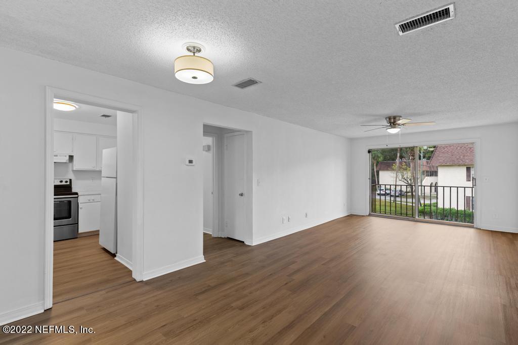 1647 El Camino Road, Unit 5 Jacksonville, FL 32216 - Photo 9 of 44 a view of an empty room with wooden floor and a window