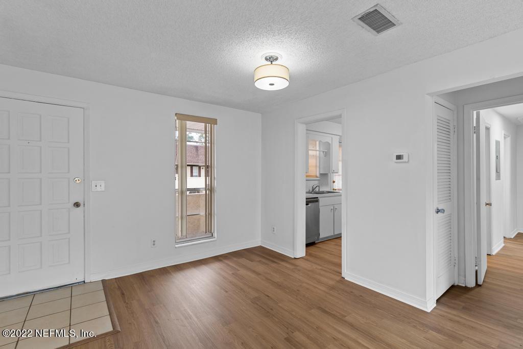 1647 El Camino Road, Unit 5 Jacksonville, FL 32216 - Photo 10 of 44 a view of a hallway with wooden floor and a living room