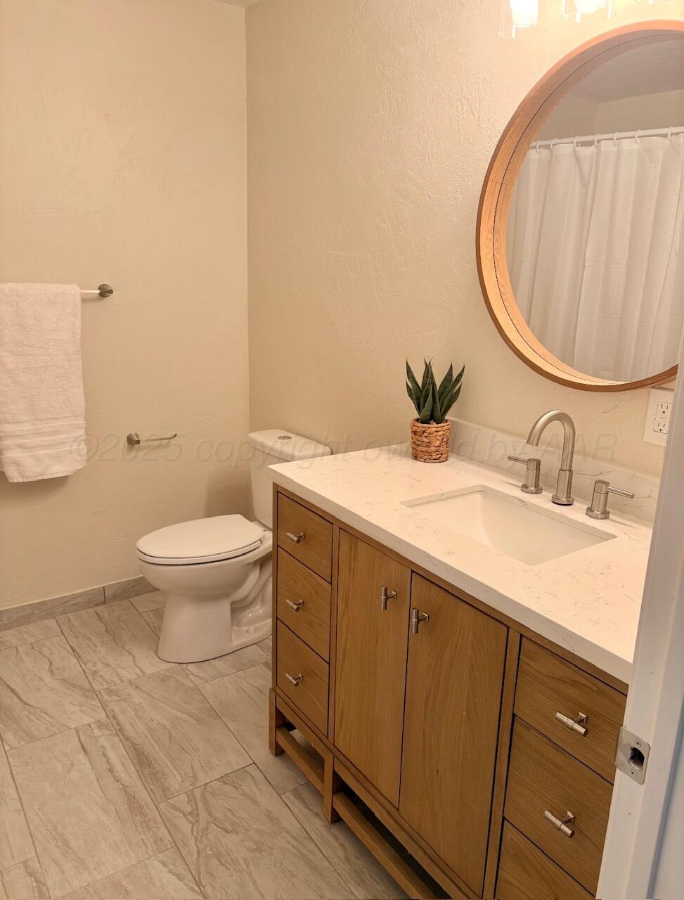 1114 Parr Street Amarillo, TX 79106 - Photo 18 of 28 a bathroom with a sink and a mirror