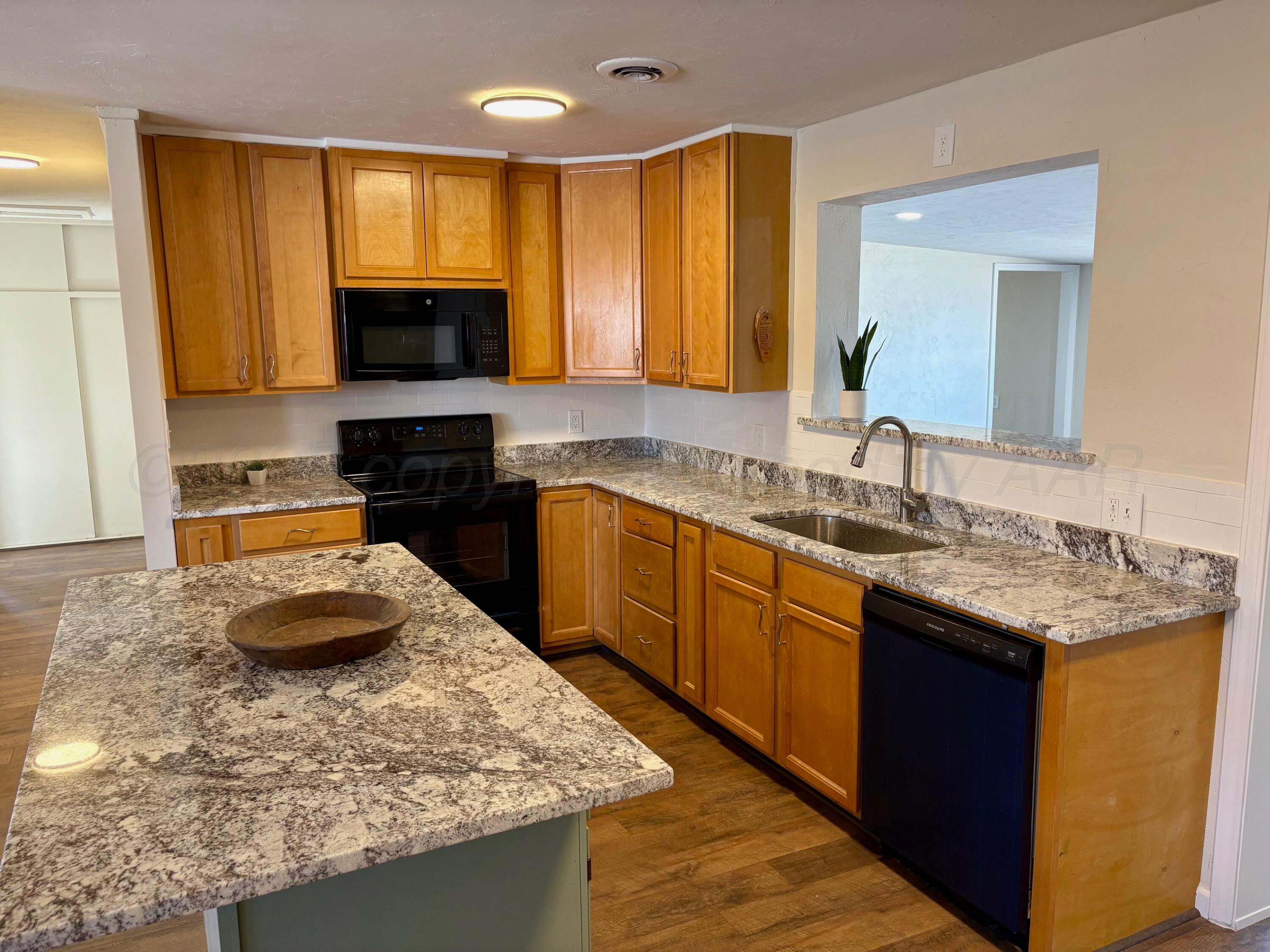 1114 Parr Street Amarillo, TX 79106 - Photo 7 of 28 a kitchen with stainless steel appliances granite countertop a sink stove and refrigerator