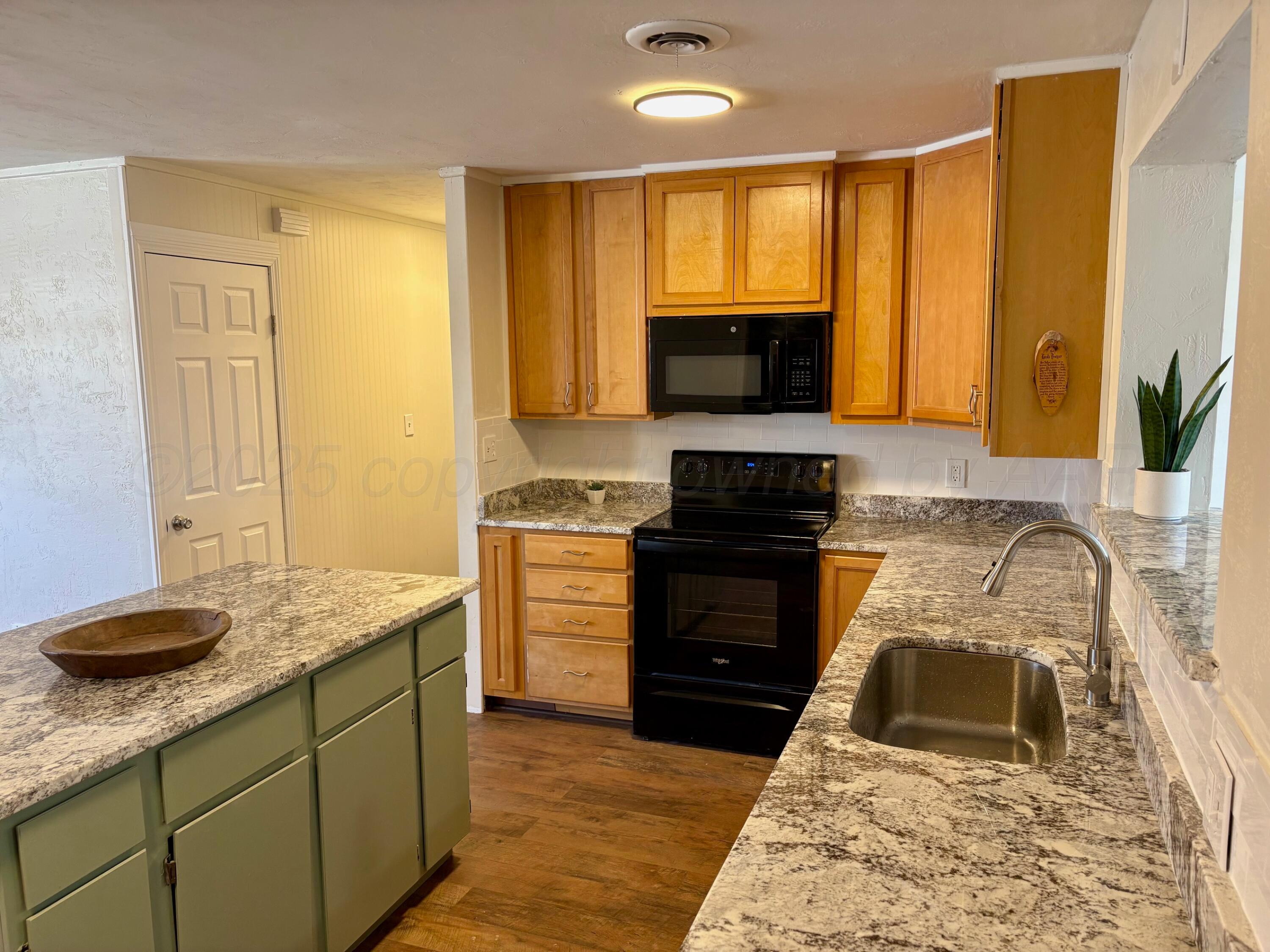 1114 Parr Street Amarillo, TX 79106 - Photo 8 of 28 a kitchen with granite countertop a sink stainless steel appliances and cabinets