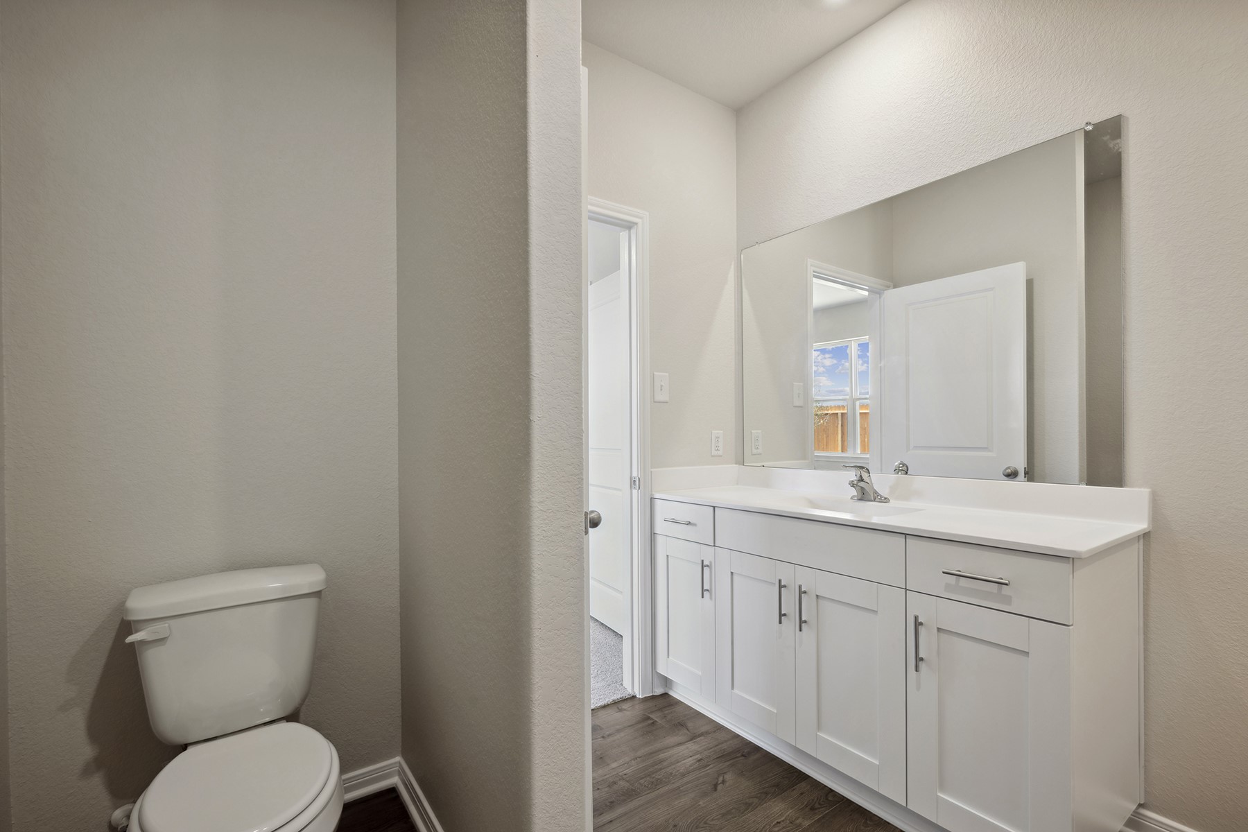 10338 Red Cardinal Drive Cleveland, TX 77328 - Photo 15 of 25 a bathroom with a toilet a sink and mirror
