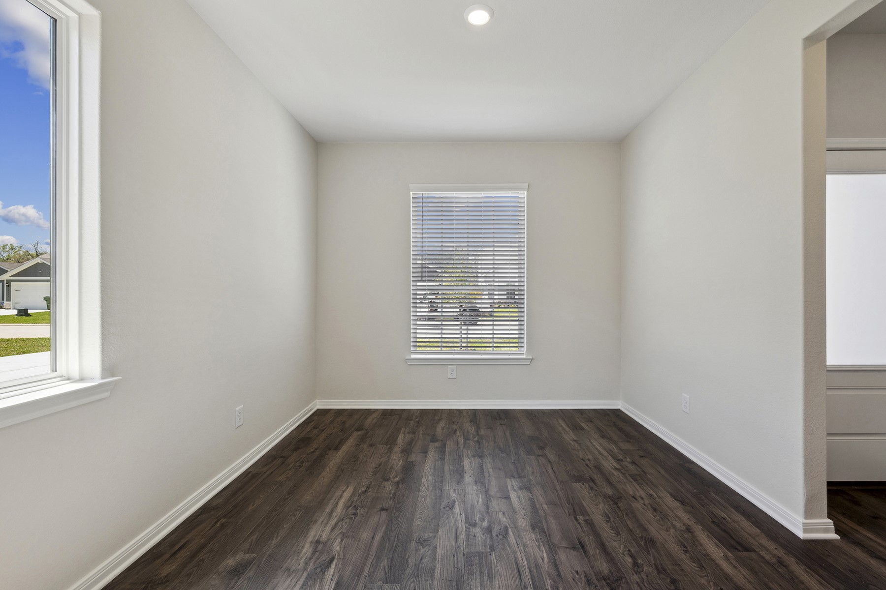 10338 Red Cardinal Drive Cleveland, TX 77328 - Photo 4 of 25 an empty room with wooden floor and windows