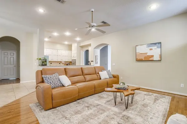 a living room with furniture and kitchen view