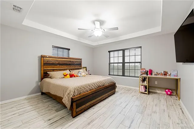 a bedroom with a bed and flat screen tv