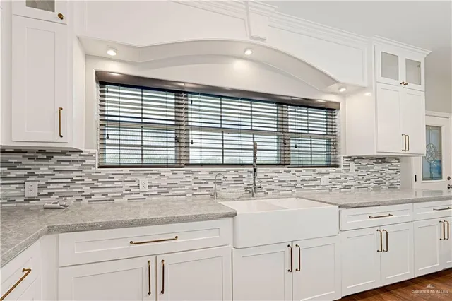 a kitchen with sink and cabinets