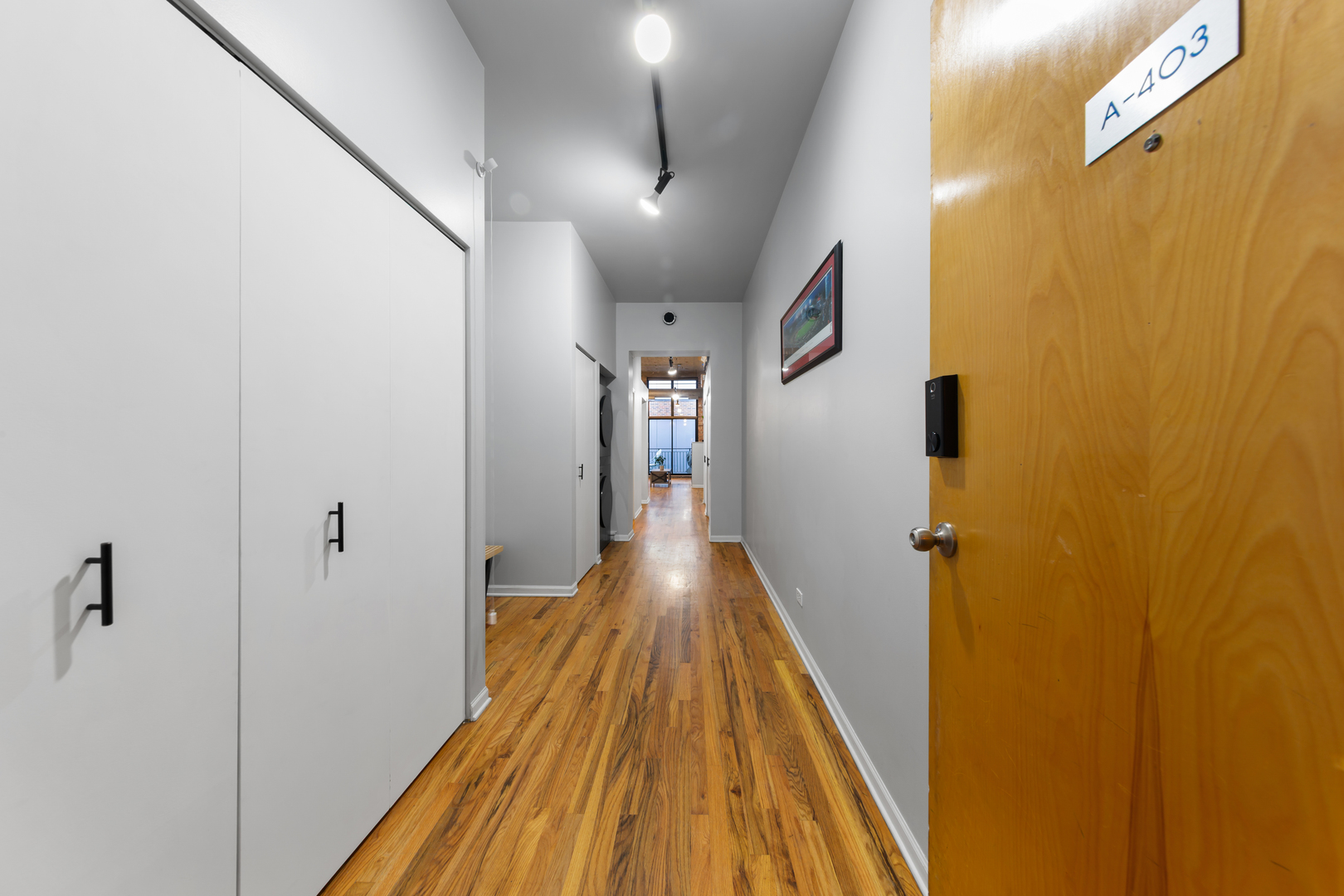 215 North Aberdeen Street, Unit 403A Chicago, IL 60607 - Photo 13 of 22 a view of a hallway with wooden floor and staircase