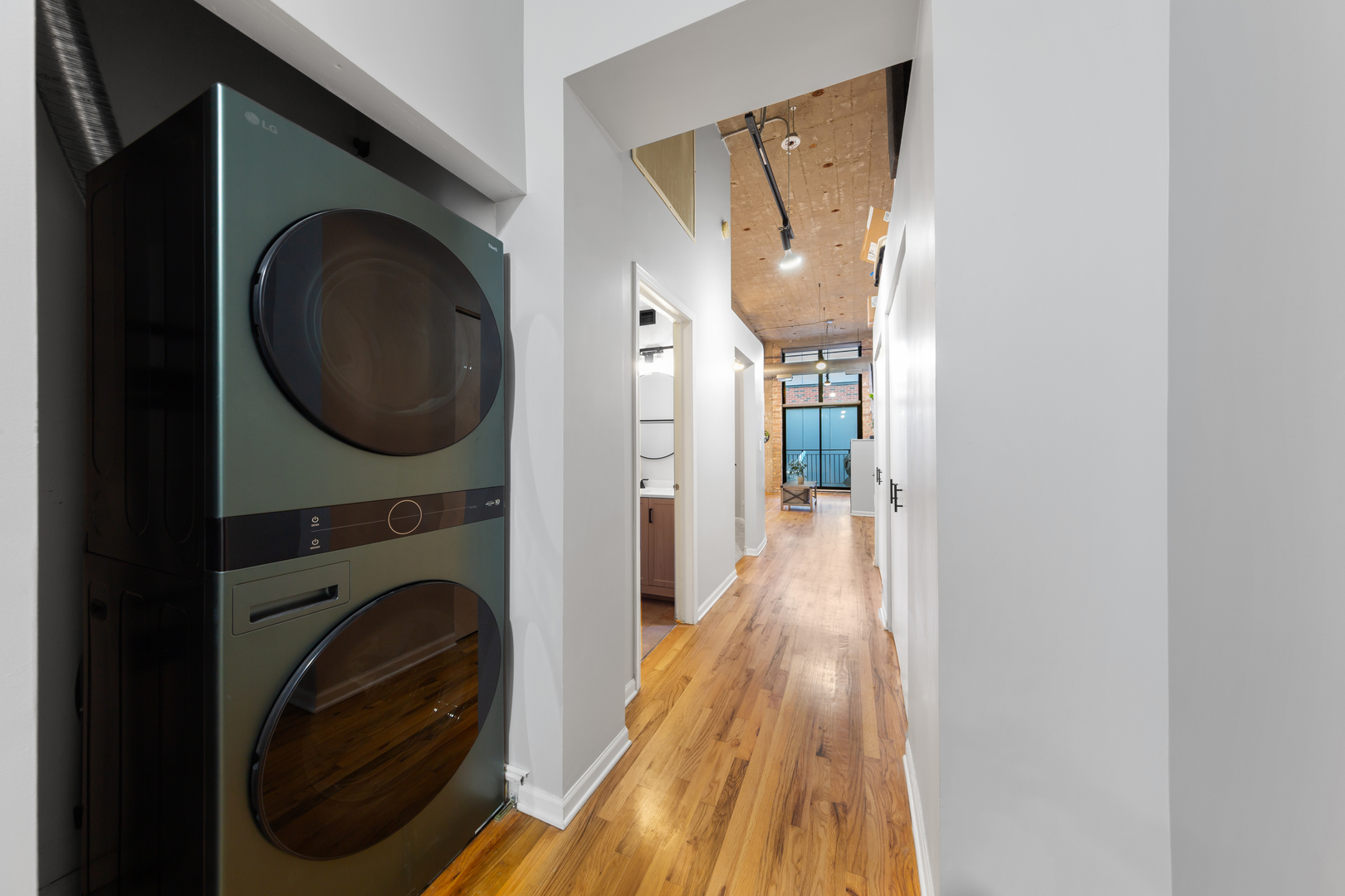 215 North Aberdeen Street, Unit 403A Chicago, IL 60607 - Photo 18 of 22 a view of a hallway with washer and dryer