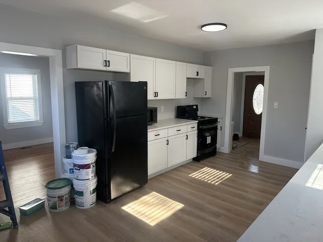 a kitchen with a refrigerator and window
