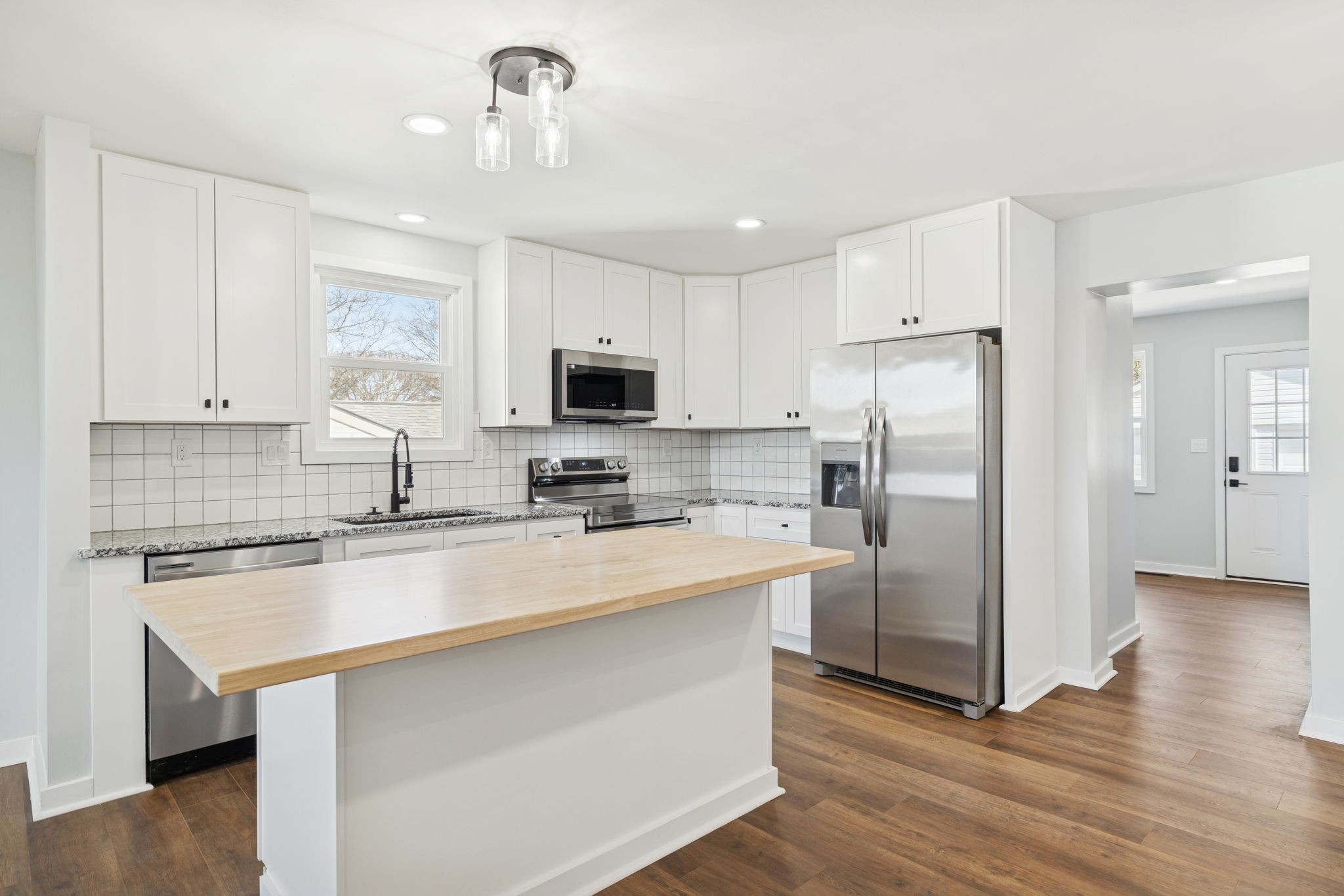 3103 Hillside Road Nashville, TN 37207 - Photo 1 of 23 a kitchen with refrigerator cabinets and wooden floor