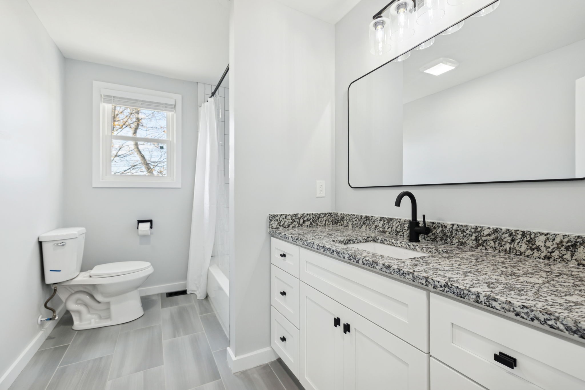 3103 Hillside Road Nashville, TN 37207 - Photo 14 of 23 a bathroom with a granite countertop sink a toilet and a mirror