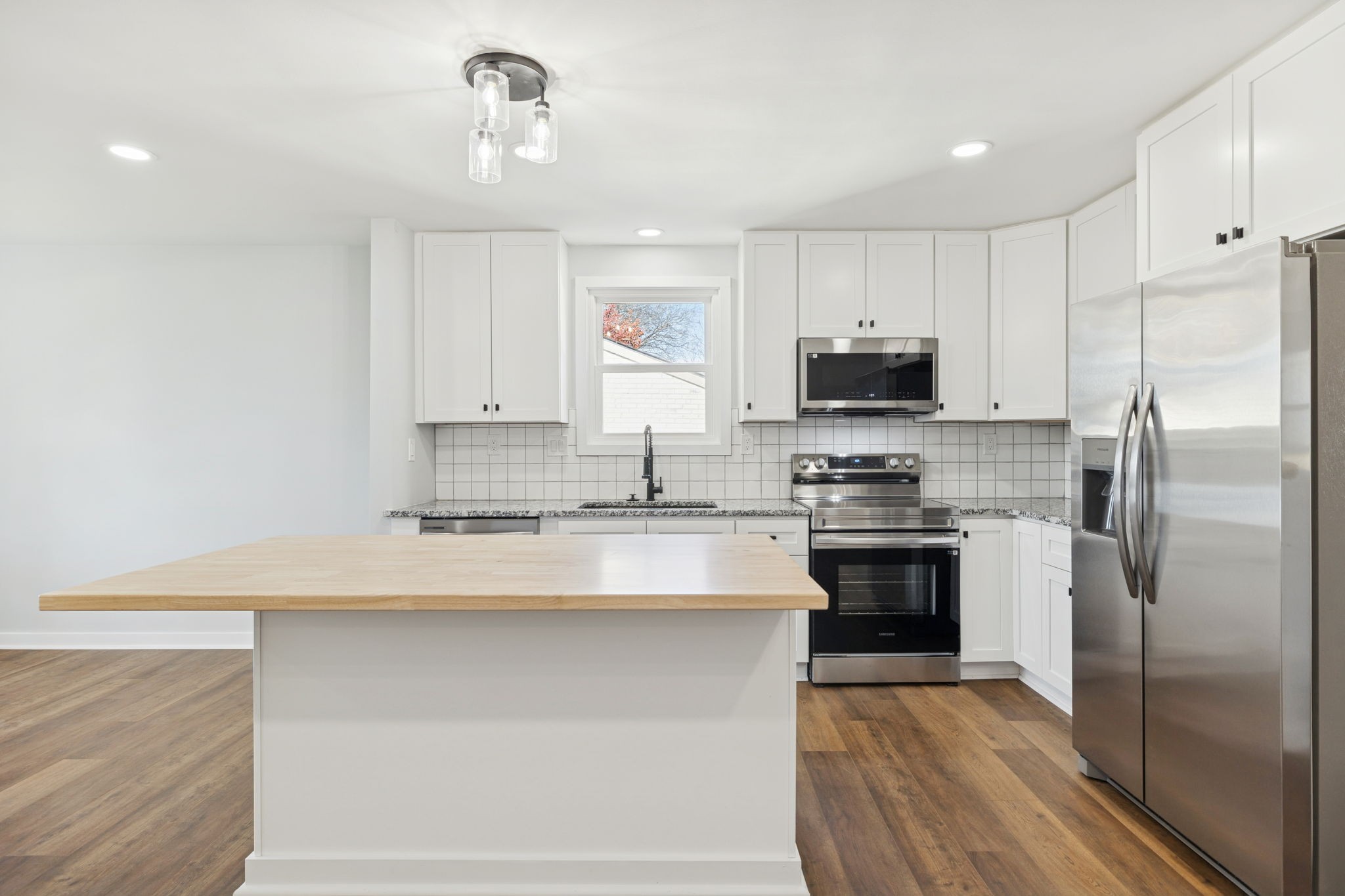 3103 Hillside Road Nashville, TN 37207 - Photo 3 of 23 a kitchen with kitchen island granite countertop a stove a sink and a refrigerator
