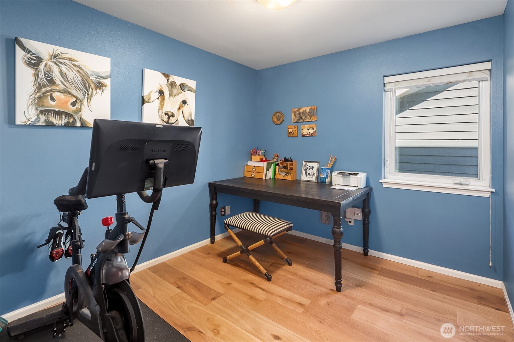 2116 California Avenue Southwest, Unit 201 Seattle, WA 98116 - Photo 11 of 17 a workspace with furniture and wooden floor