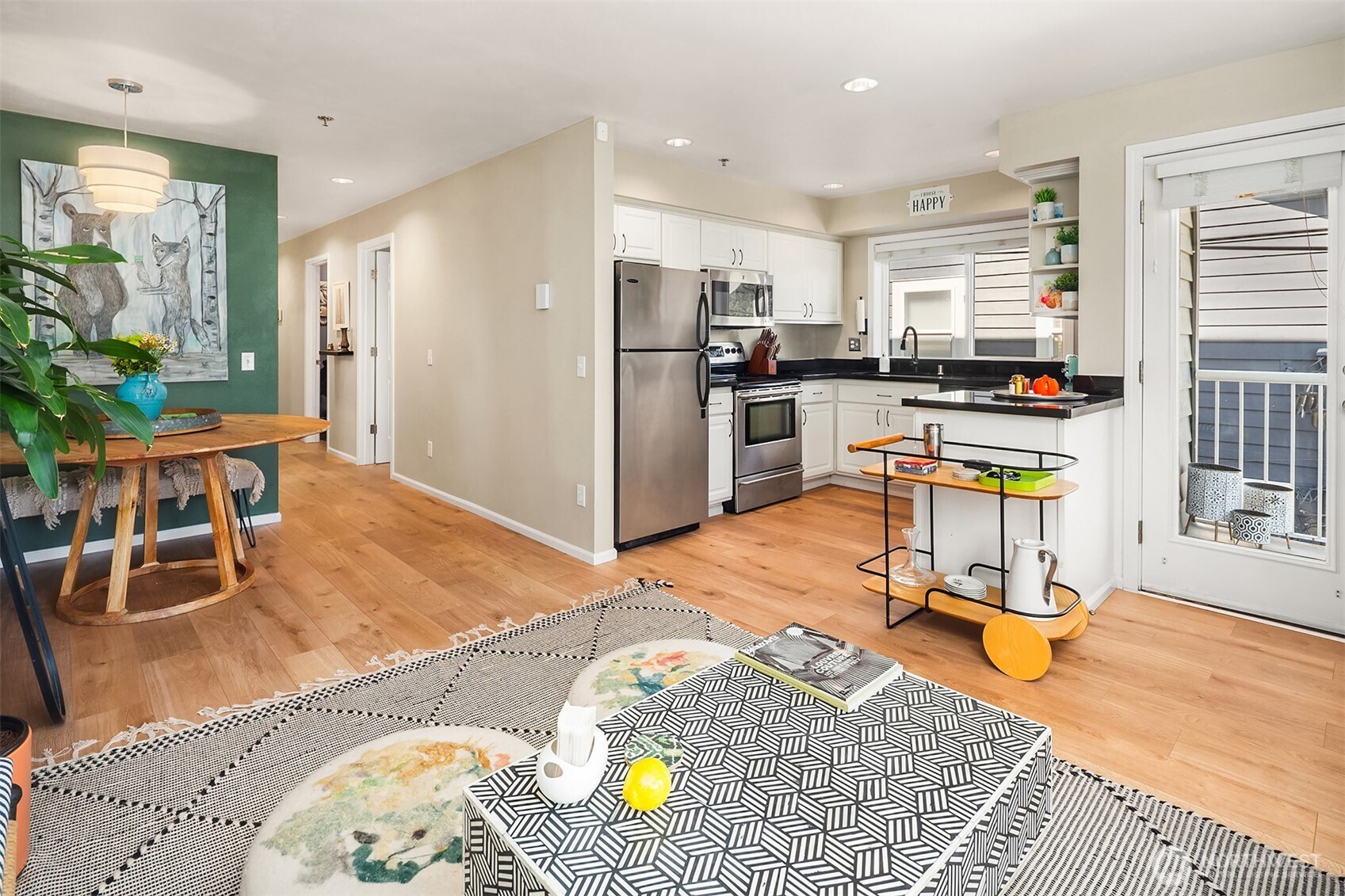 2116 California Avenue Southwest, Unit 201 Seattle, WA 98116 - Photo 5 of 17 a living room filled with furniture and kitchen view