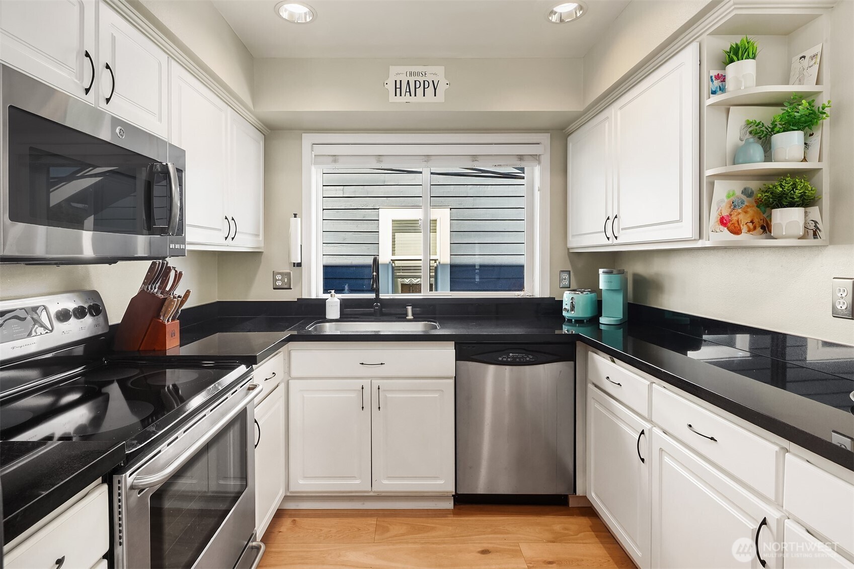 2116 California Avenue Southwest, Unit 201 Seattle, WA 98116 - Photo 6 of 17 a kitchen with stainless steel appliances granite countertop a sink stove top oven and cabinets