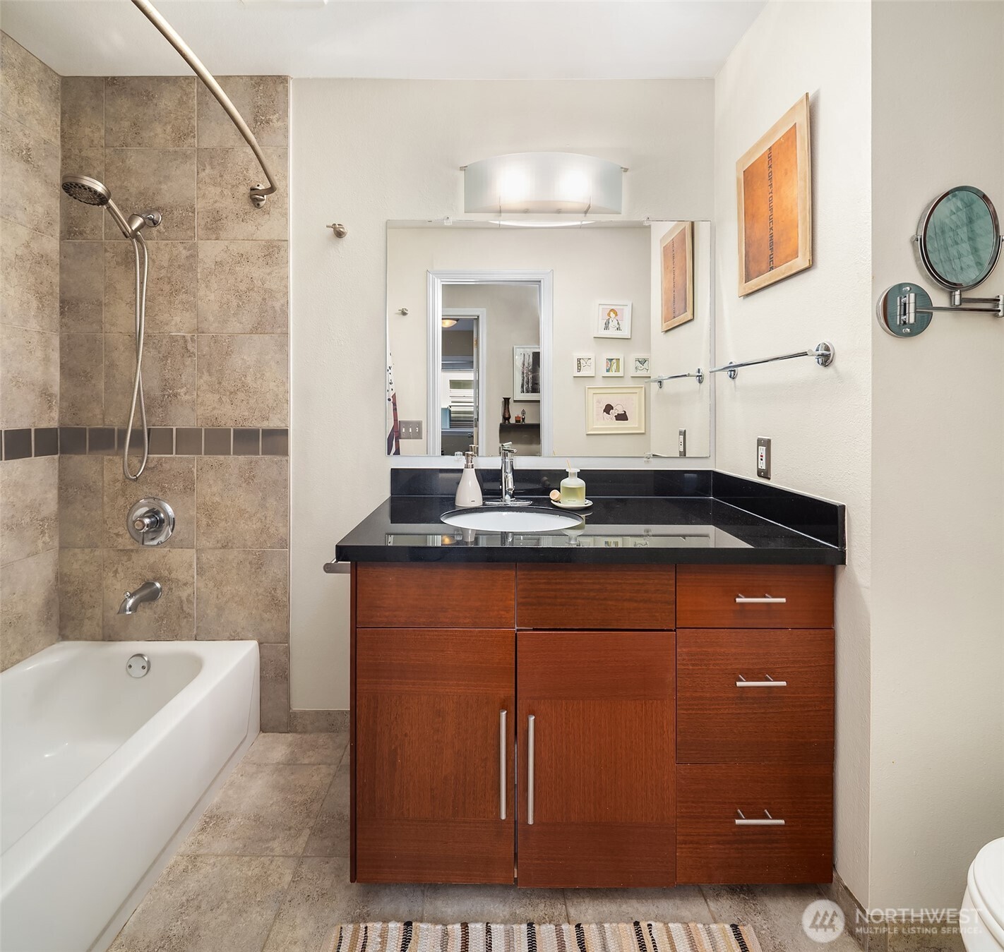 2116 California Avenue Southwest, Unit 201 Seattle, WA 98116 - Photo 10 of 17 a bathroom with a sink a mirror and a bathtub