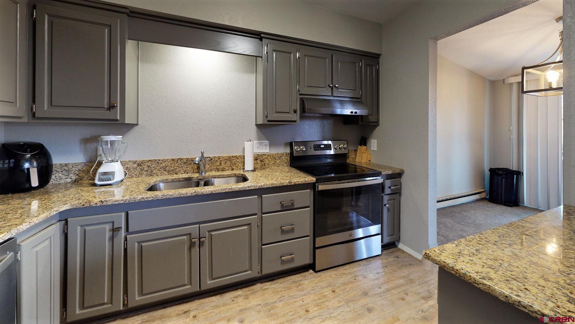 255 Pine Ridge Loop, Unit C5 Durango, CO 81301 - Photo 11 of 32 a kitchen with stainless steel appliances granite countertop a stove a sink and a microwave