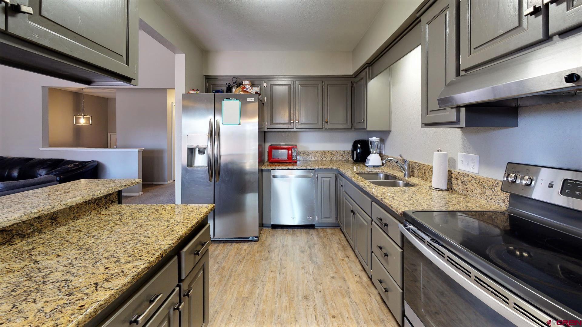255 Pine Ridge Loop, Unit C5 Durango, CO 81301 - Photo 12 of 32 a kitchen with stainless steel appliances granite countertop a lot of counter space