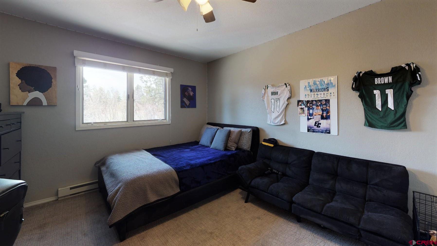 255 Pine Ridge Loop, Unit C5 Durango, CO 81301 - Photo 14 of 32 a bedroom with bed couch and window