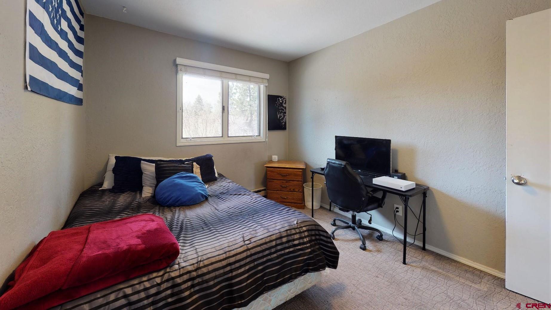 255 Pine Ridge Loop, Unit C5 Durango, CO 81301 - Photo 16 of 32 a bedroom with a bed and chair
