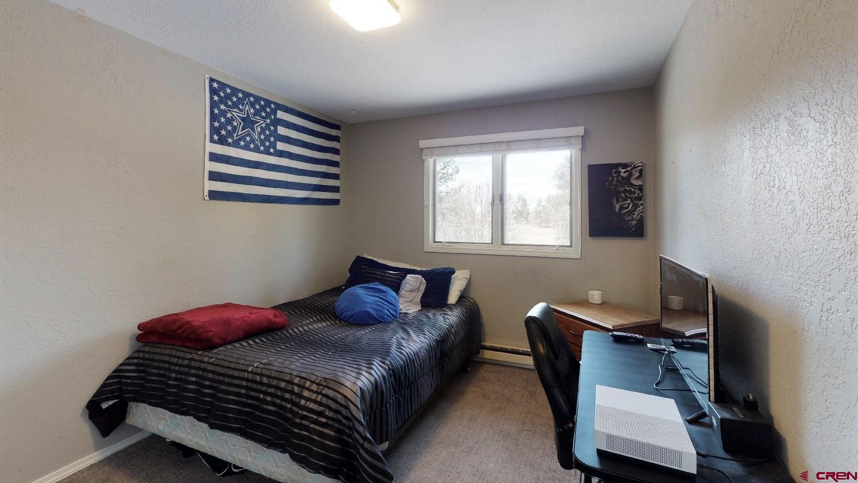 255 Pine Ridge Loop, Unit C5 Durango, CO 81301 - Photo 17 of 32 a bedroom with a bed and a window