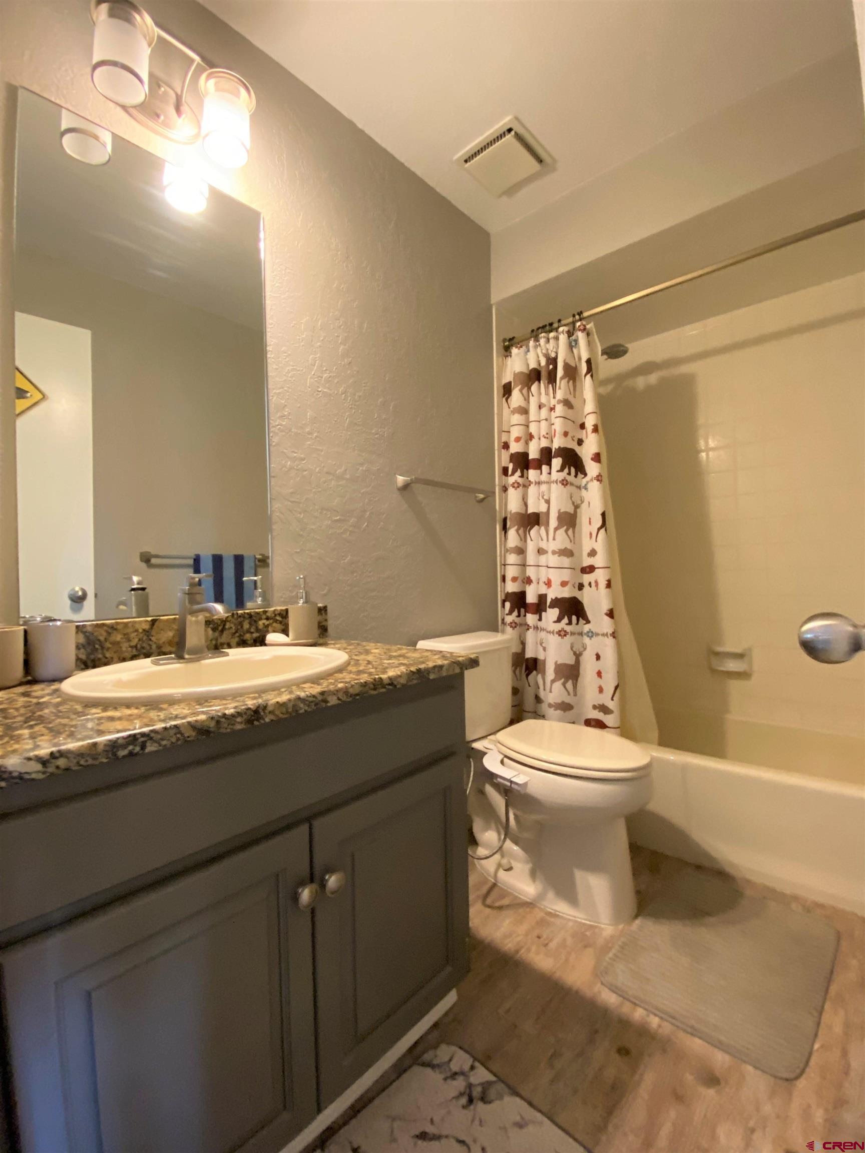 255 Pine Ridge Loop, Unit C5 Durango, CO 81301 - Photo 19 of 32 a bathroom with a granite countertop toilet sink and mirror