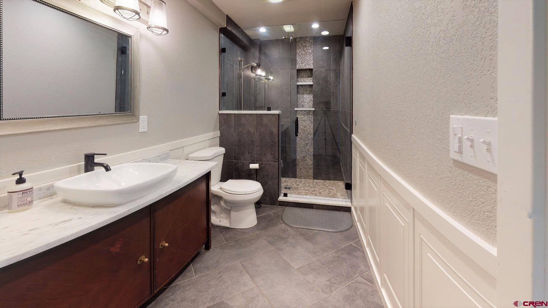 255 Pine Ridge Loop, Unit C5 Durango, CO 81301 - Photo 21 of 32 a bathroom with a toilet sink and mirror