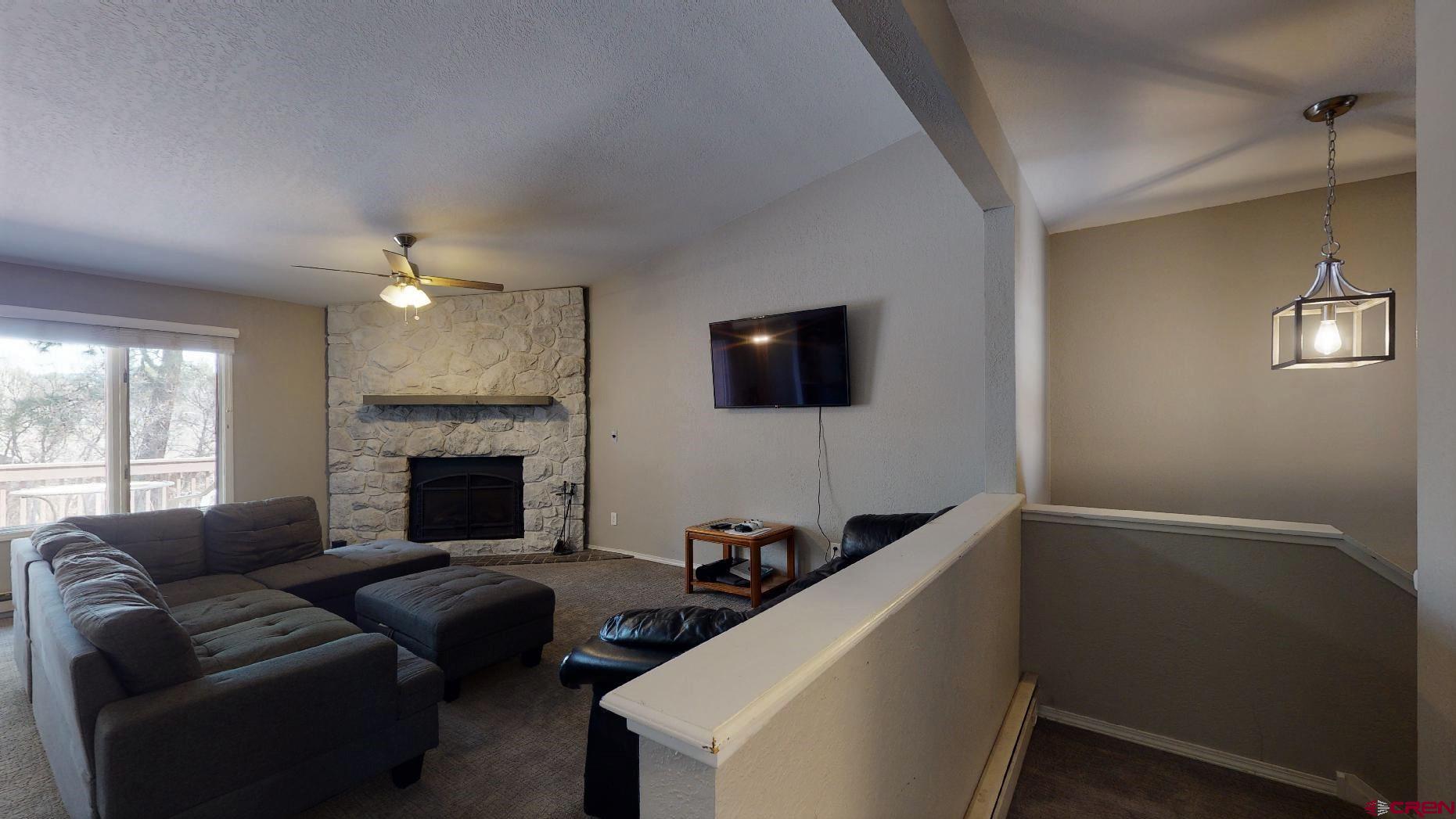 255 Pine Ridge Loop, Unit C5 Durango, CO 81301 - Photo 4 of 32 a living room with furniture and a fireplace