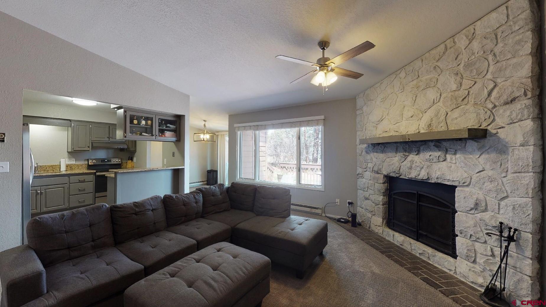 255 Pine Ridge Loop, Unit C5 Durango, CO 81301 - Photo 5 of 32 a living room with furniture and a fireplace