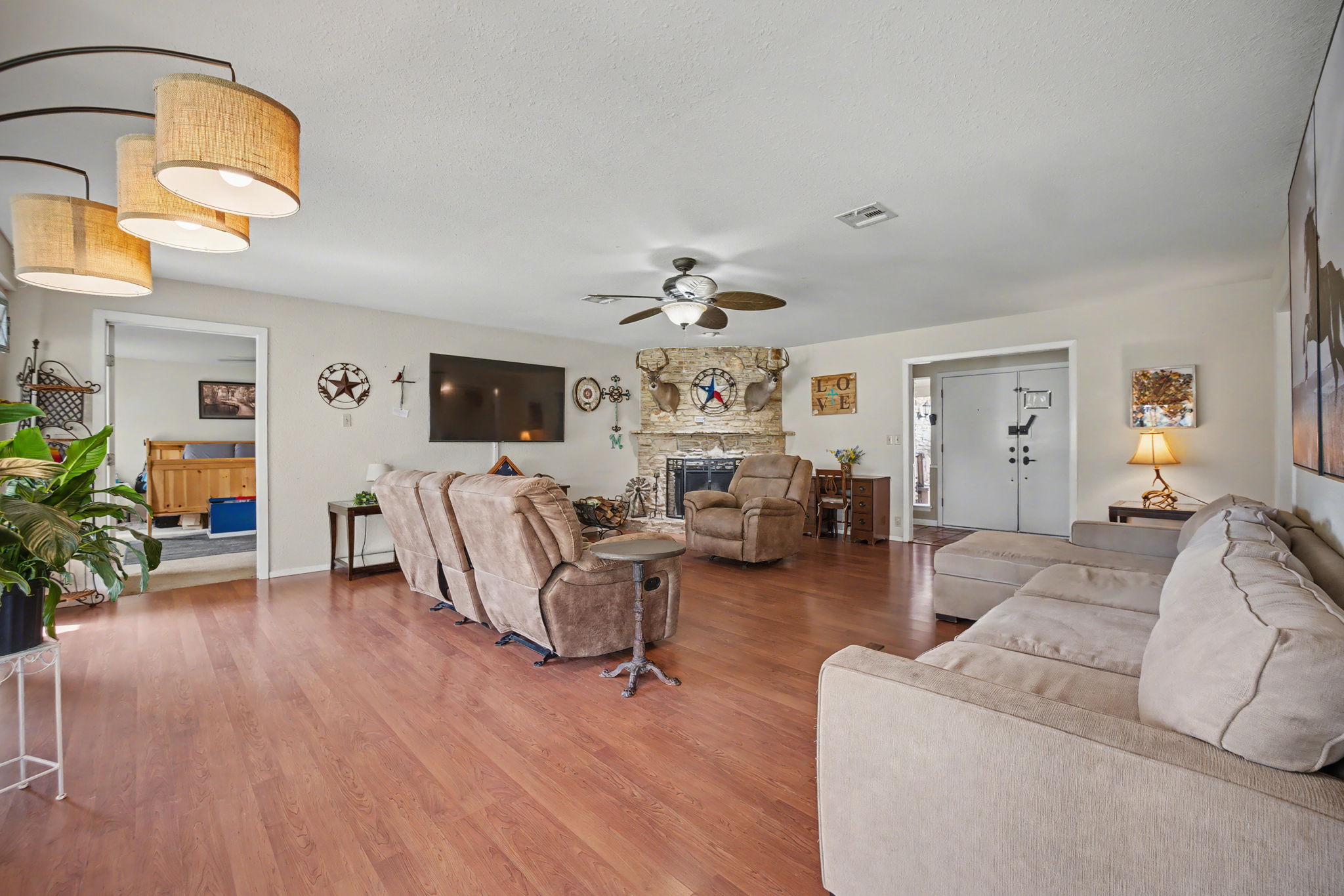 103 Oak Ridge Circle Georgetown, TX 78628 - Photo 11 of 22 Living room featuring wood finished floors, a fireplace, ceiling fan, and a textured ceiling