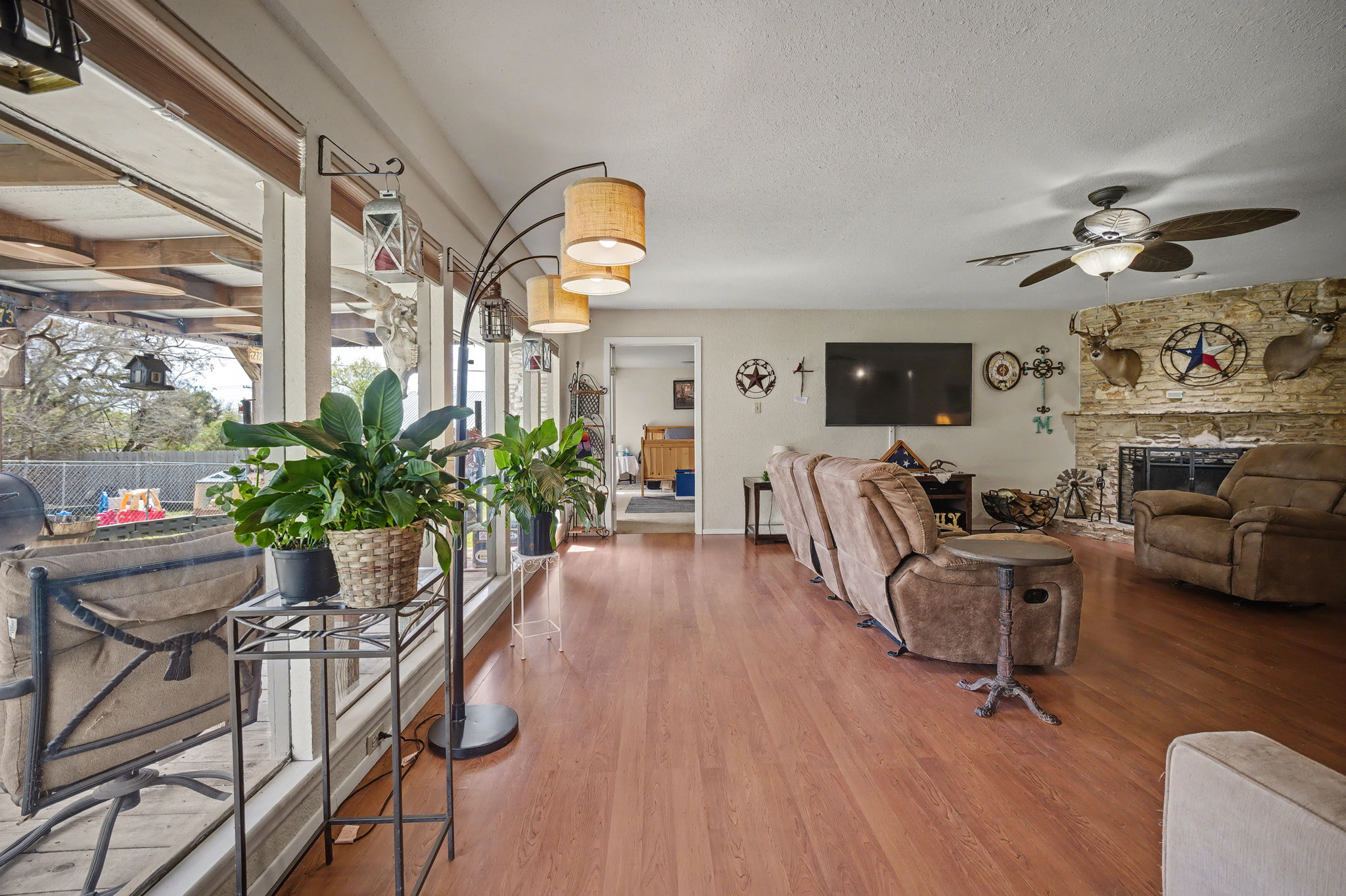 103 Oak Ridge Circle Georgetown, TX 78628 - Photo 12 of 22 Living area featuring wood finished floors, a fireplace, a ceiling fan, and a textured ceiling