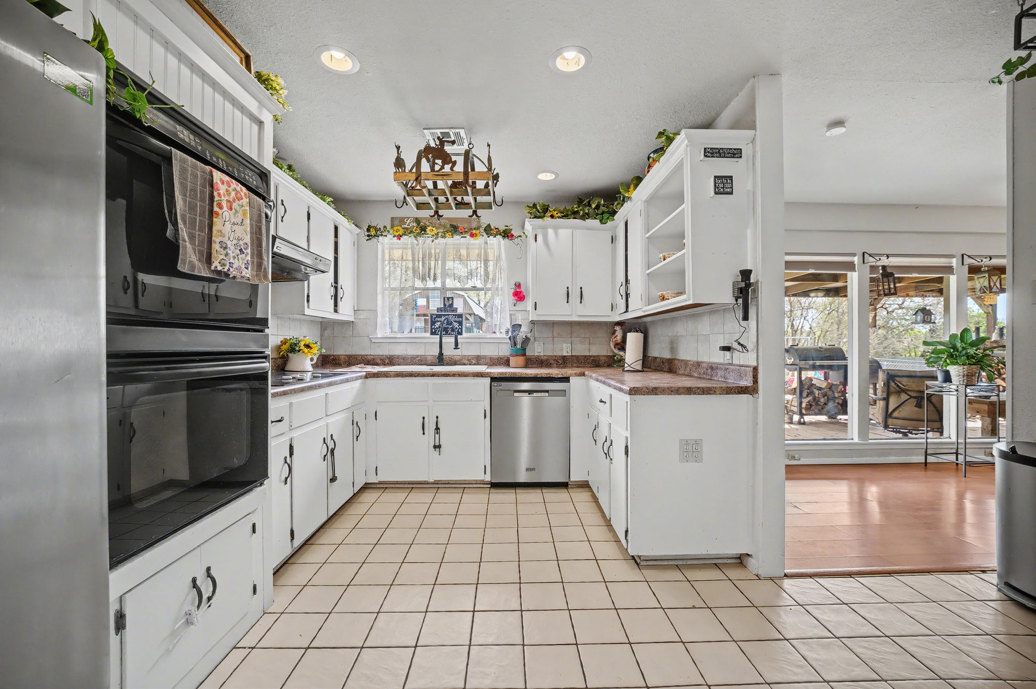 103 Oak Ridge Circle Georgetown, TX 78628 - Photo 14 of 22 Kitchen with stainless steel appliances, white cabinets, backsplash, recessed lighting, and light tile patterned floors