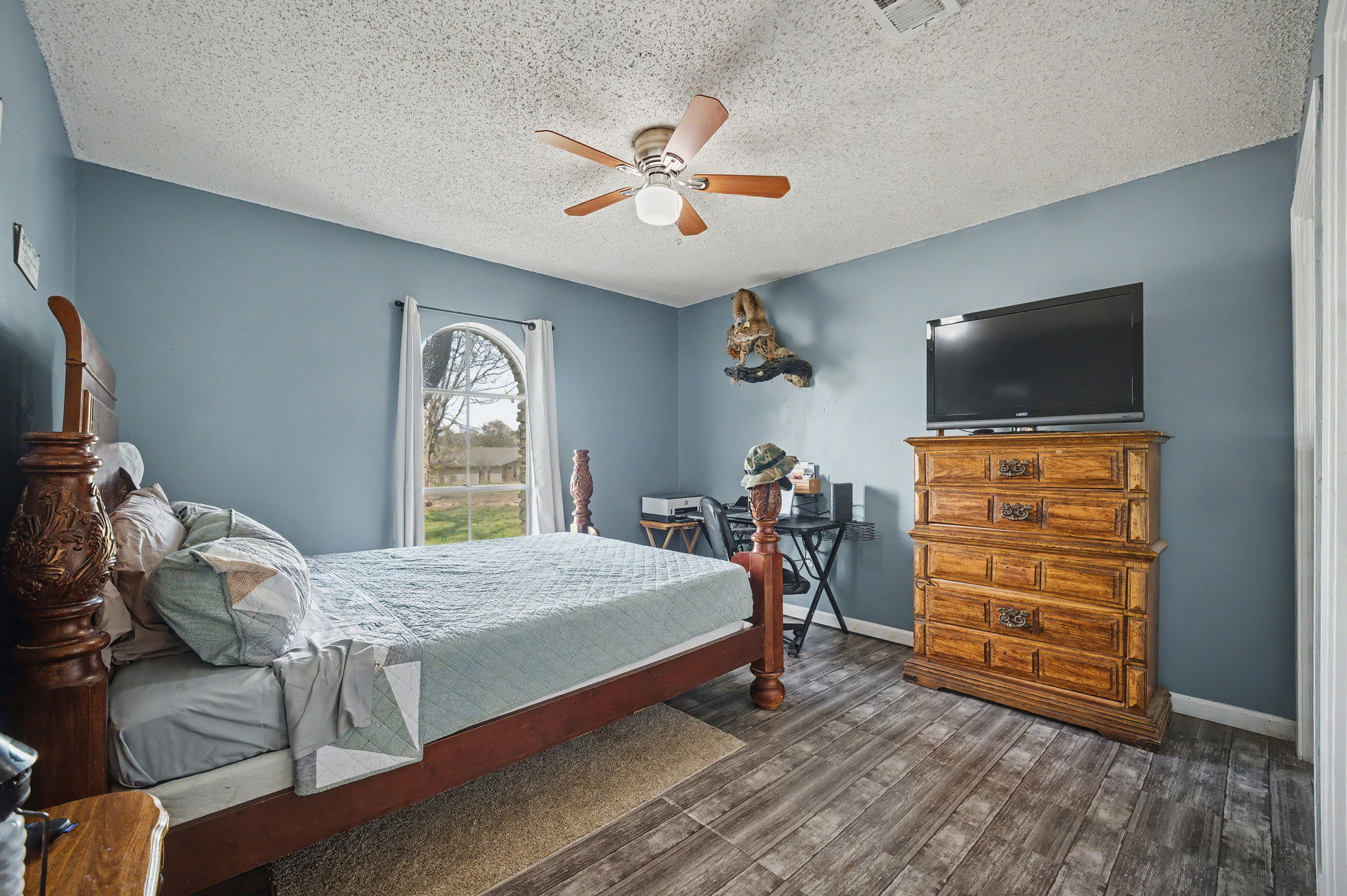 103 Oak Ridge Circle Georgetown, TX 78628 - Photo 19 of 22 Bedroom featuring dark wood-style flooring, ceiling fan, and a textured ceiling