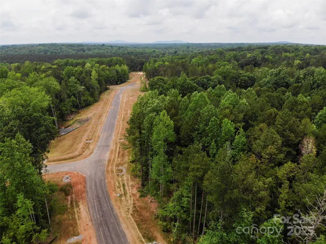 a view of a lake with houses in the back