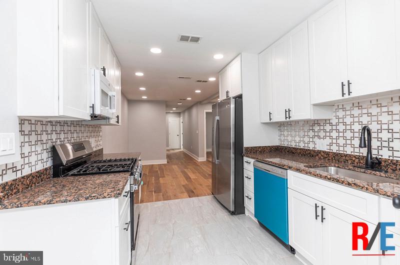 4100 Queensbury Road Hyattsville, MD 20781 - Photo 12 of 24 Modern kitchen with sleek finishes.