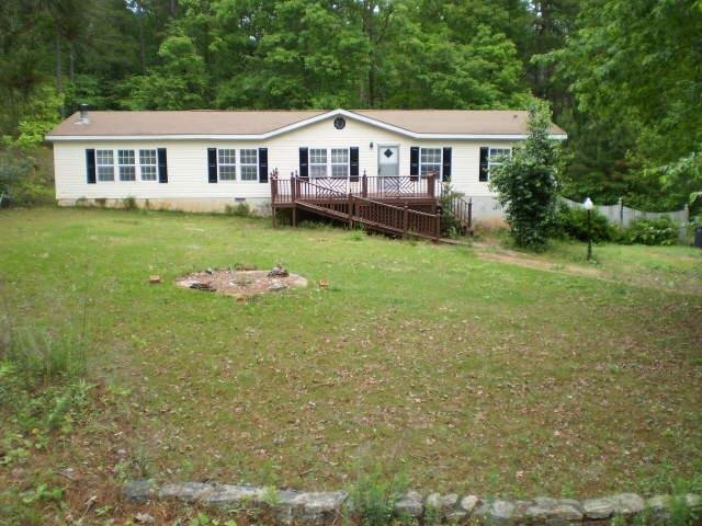 2810 Miranda Ridge Drive Monroe, GA 30655 - Photo 1 of 1 a front view of a house with a garden and trees