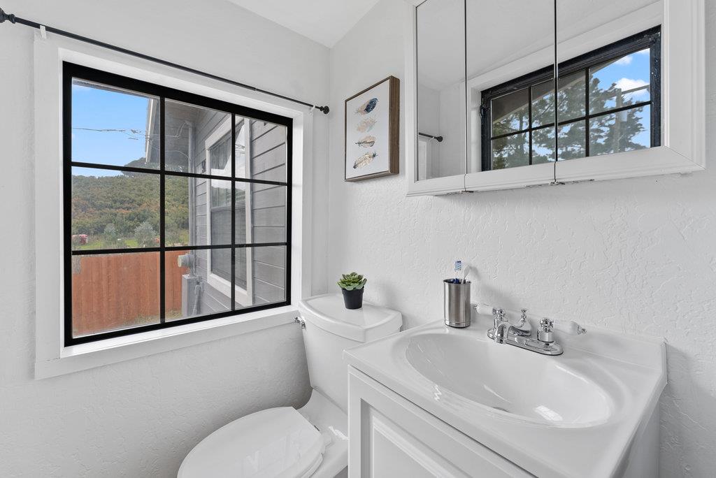 98 Paddon Road Watsonville, CA 95076 - Photo 21 of 28 a bathroom with a toilet sink and mirror