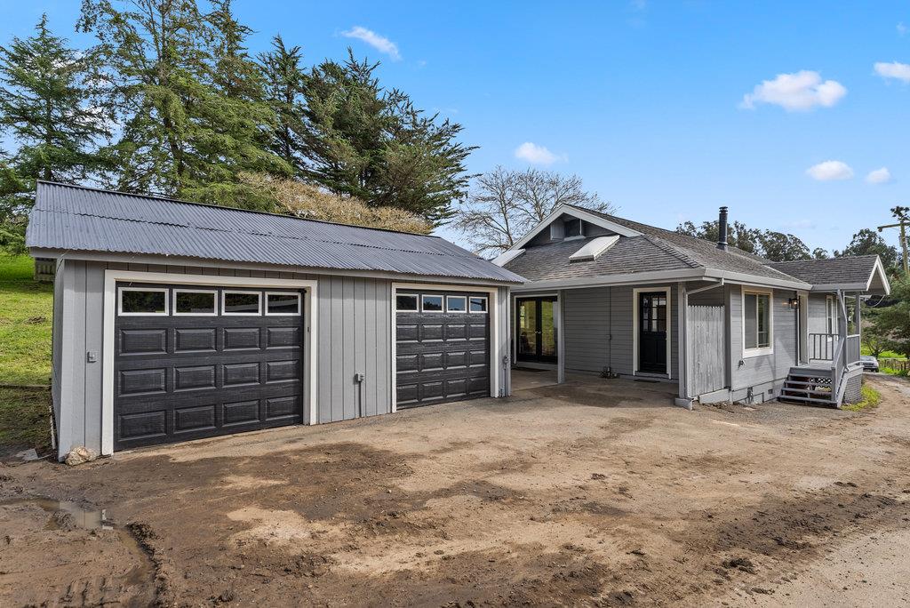 98 Paddon Road Watsonville, CA 95076 - Photo 3 of 28 a front view of a house with a yard and garage