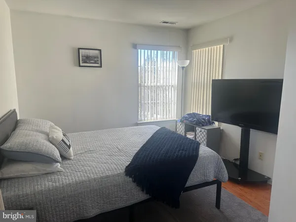 a bedroom with a bed chair and window