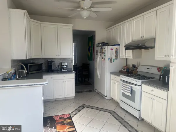 a kitchen with stainless steel appliances granite countertop a refrigerator sink and stove