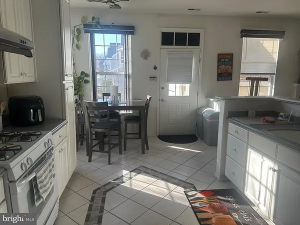 a kitchen with stainless steel appliances kitchen island granite countertop a sink and cabinets