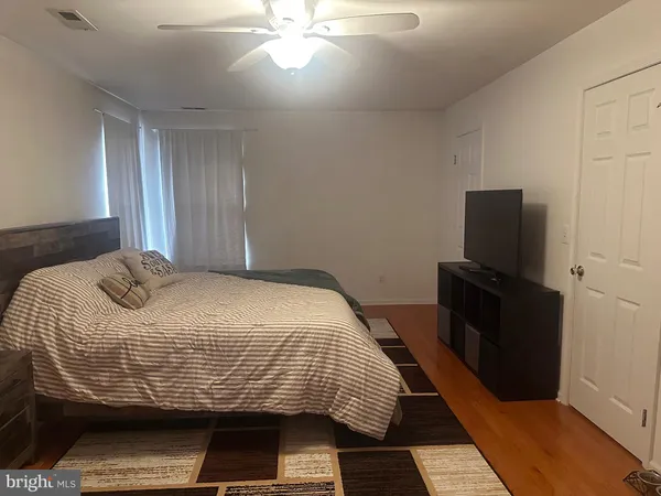 a bedroom with bed and window