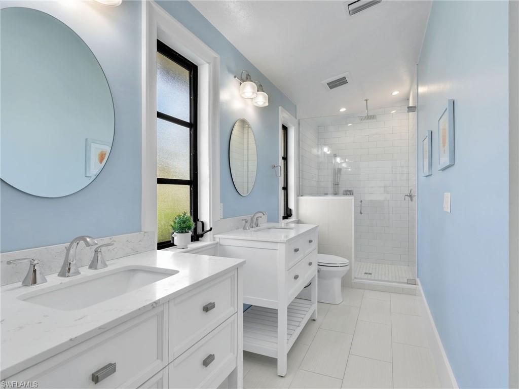 188 Columbus Way Marco Island, FL 34145 - Photo 16 of 38 Full bath with a shower stall, two vanities, light tile patterned flooring, and recessed lighting