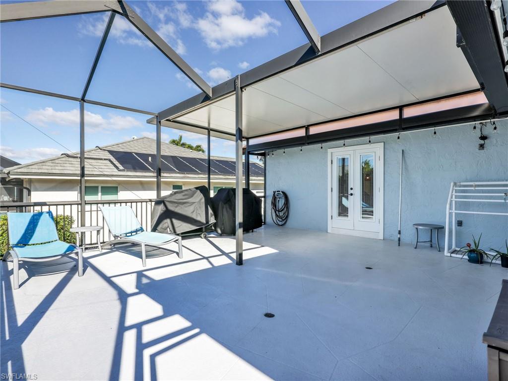 188 Columbus Way Marco Island, FL 34145 - Photo 27 of 38 View of patio / terrace with french doors, a lanai, a sunroom, and a grill