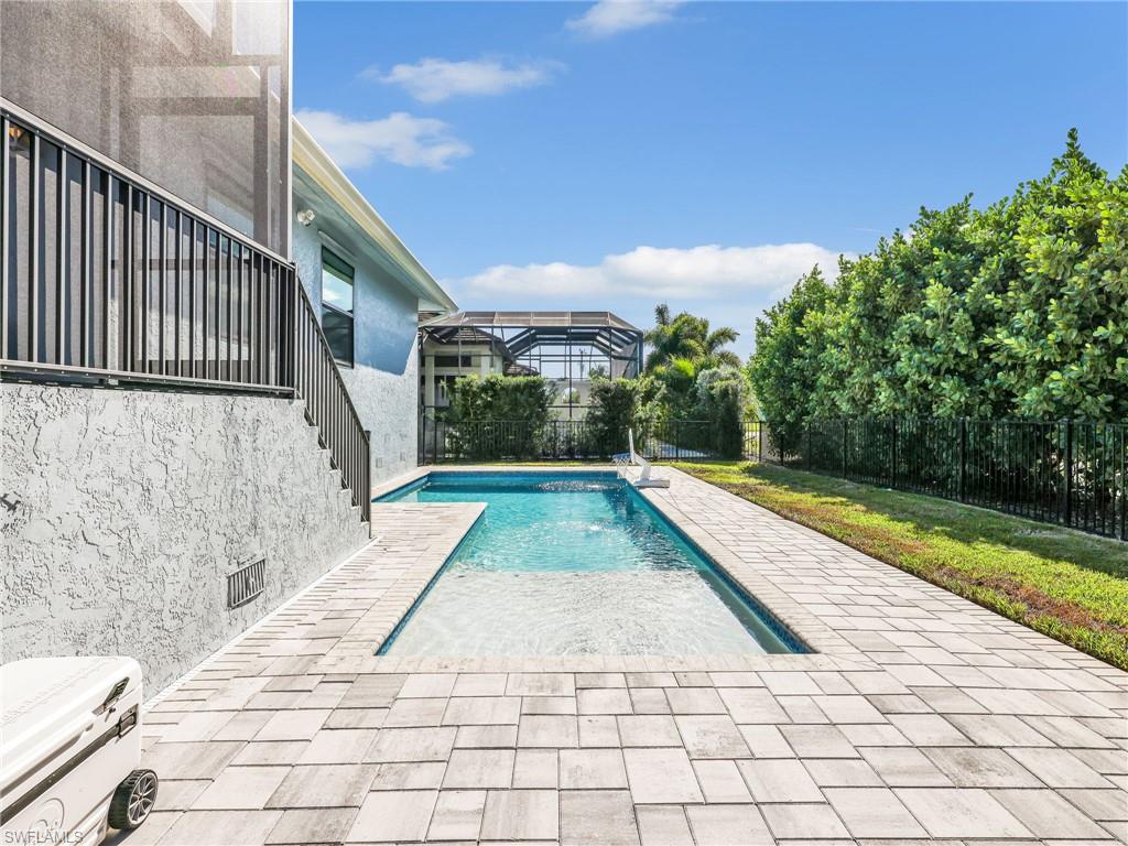 188 Columbus Way Marco Island, FL 34145 - Photo 28 of 38 View of pool featuring a patio, a fenced backyard, and a lanai