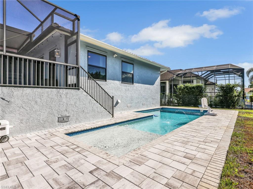 188 Columbus Way Marco Island, FL 34145 - Photo 29 of 38 View of swimming pool featuring a lanai, a patio, and a sunroom