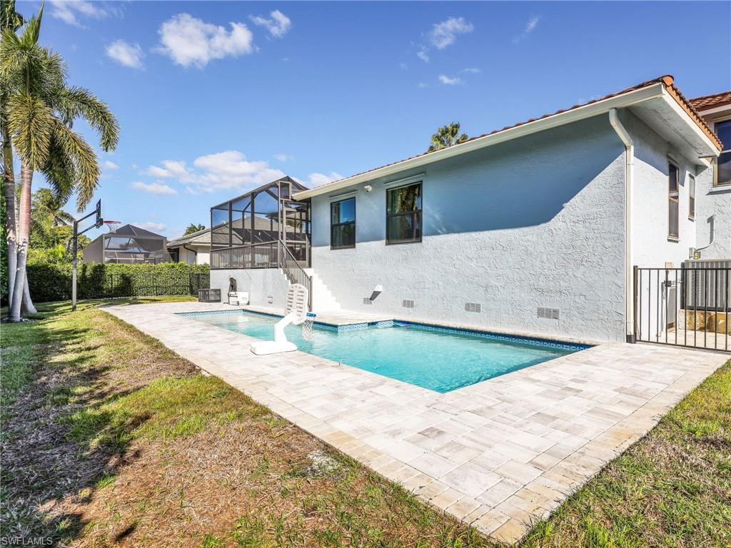 188 Columbus Way Marco Island, FL 34145 - Photo 30 of 38 Back of property with crawl space, a patio area, stucco siding, and a sunroom