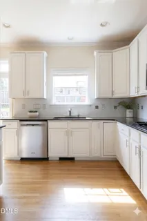 a kitchen with sink a stove and cabinets